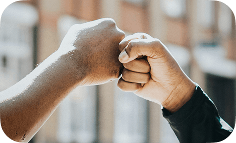 Two people fist bumping